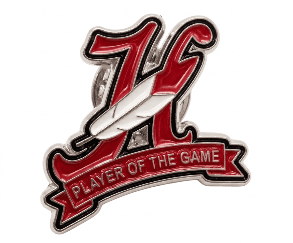 Red and silver enamel pin with letter 'A' and white feather reading 'Player of the Game'